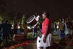 A student at Chumani High School looks through the telescope.